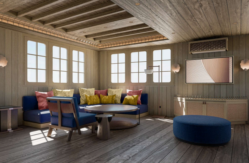 Phinisi Bhavana living and wellness area with blue upholstered sofas and ocean-view windows